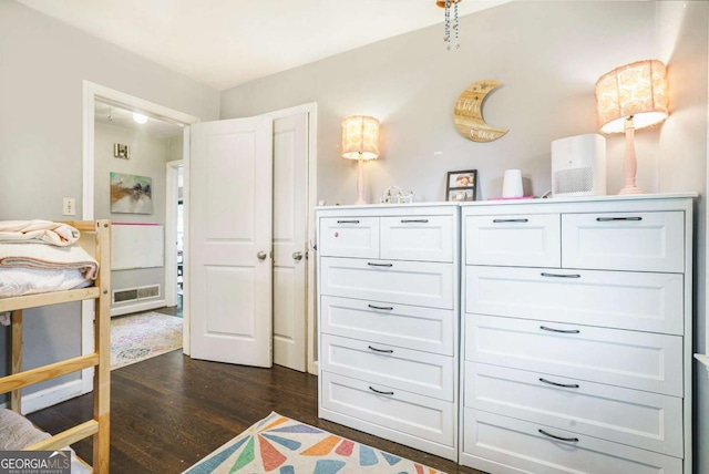 bedroom with dark wood-type flooring