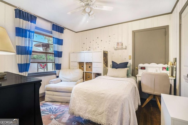 bedroom with wood finished floors, ornamental molding, and a ceiling fan
