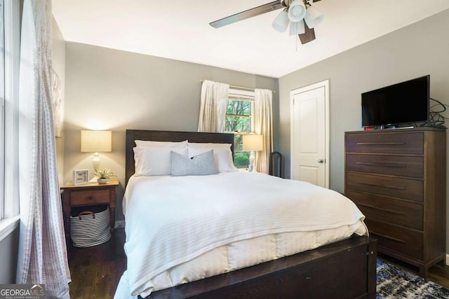 bedroom with dark wood-type flooring and ceiling fan