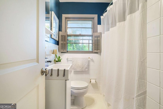 4128 Morgan Rd, Tucker, GA 30084 - full bath with tile walls, toilet, vanity, and a shower with curtain