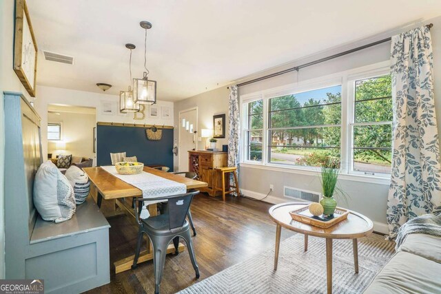 dining space with baseboards and dark wood-style flooring