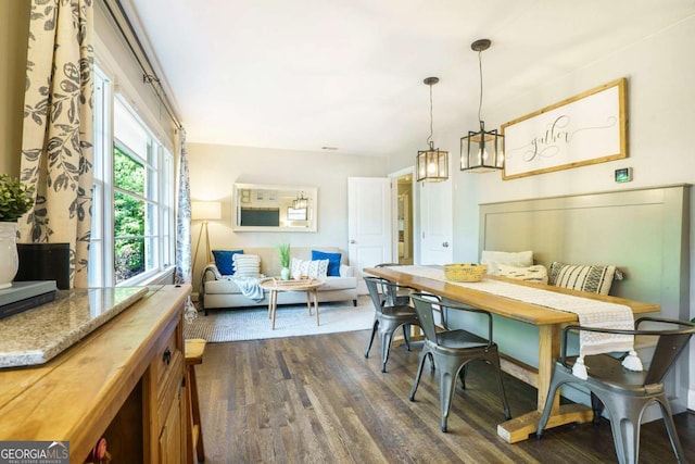 dining room featuring breakfast area and dark wood finished floors