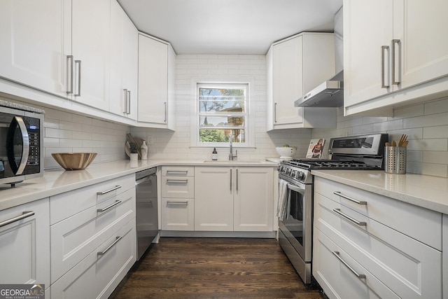 4128 Morgan Rd, Tucker, GA 30084 - kitchen featuring stainless steel appliances, dark wood finished floors, backsplash, and white cabinetry