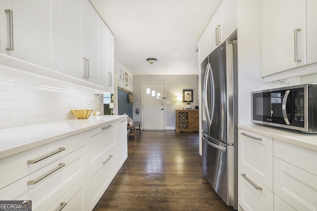 4128 Morgan Rd, Tucker, GA 30084 - kitchen with stainless steel appliances, decorative backsplash, dark wood finished floors, light countertops, and white cabinetry