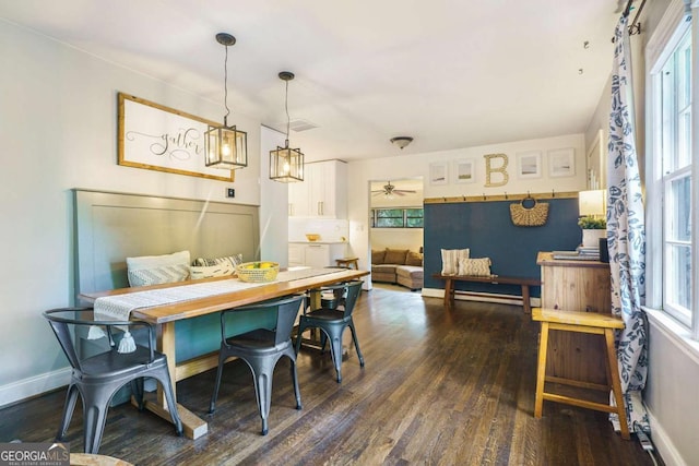dining space with dark wood-type flooring, plenty of natural light, and baseboards