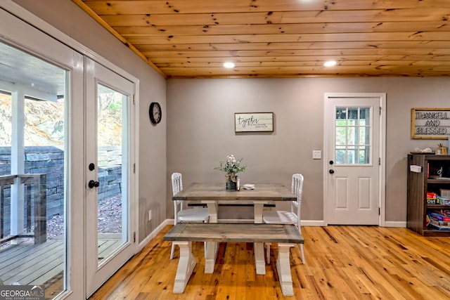 dining room featuring light wood-style floors, baseboards, wooden ceiling, and recessed lighting