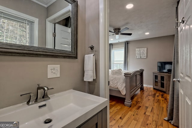 bathroom with ceiling fan, recessed lighting, wood finished floors, connected bathroom, and vanity