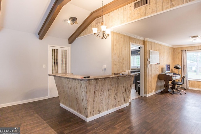 indoor dry bar featuring baseboards, dark wood finished floors, a chandelier, wood walls, and pendant lighting