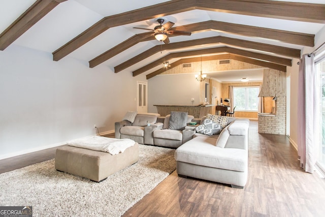 living room featuring wood finished floors, a ceiling fan, and baseboards