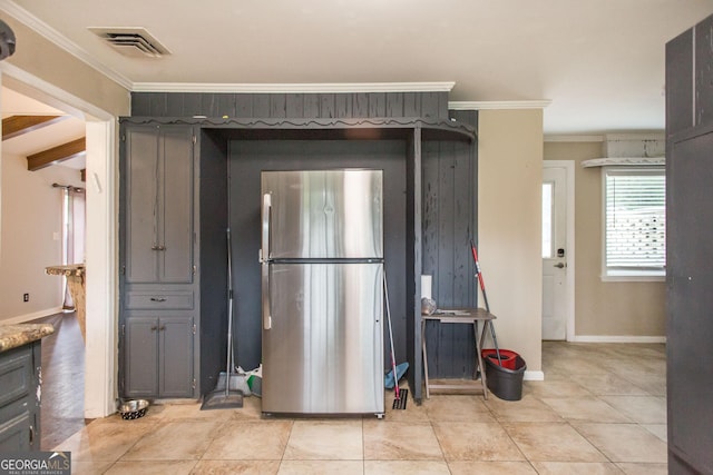 kitchen featuring freestanding refrigerator, crown molding, baseboards, and gray cabinets