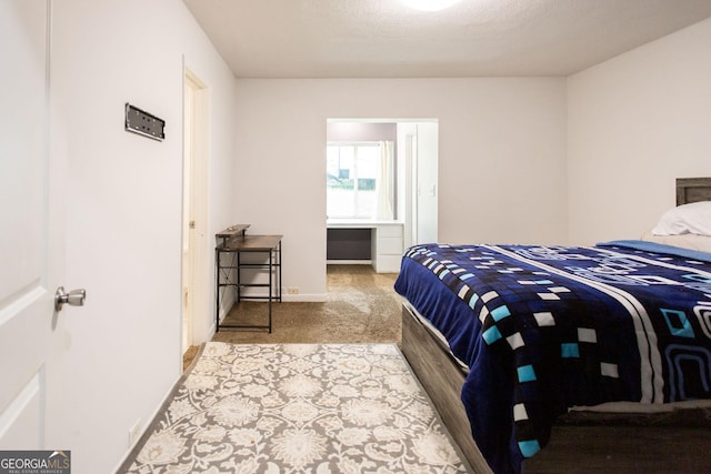 bedroom featuring carpet and baseboards