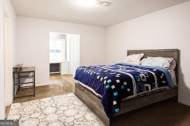 bedroom with carpet floors and baseboards