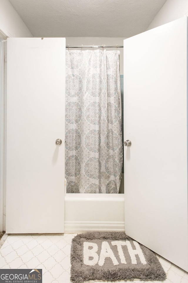 full bathroom with shower / bath combo with shower curtain