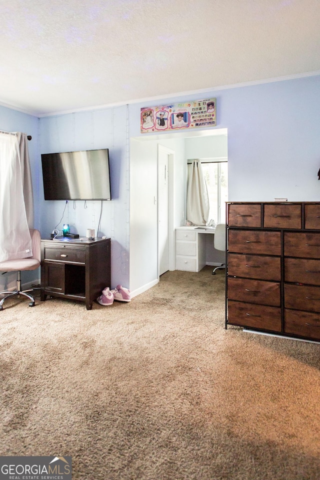 bedroom with carpet flooring, a desk, and crown molding