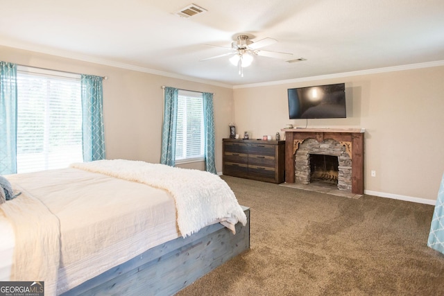 carpeted bedroom with crown molding, a fireplace, ceiling fan, and baseboards