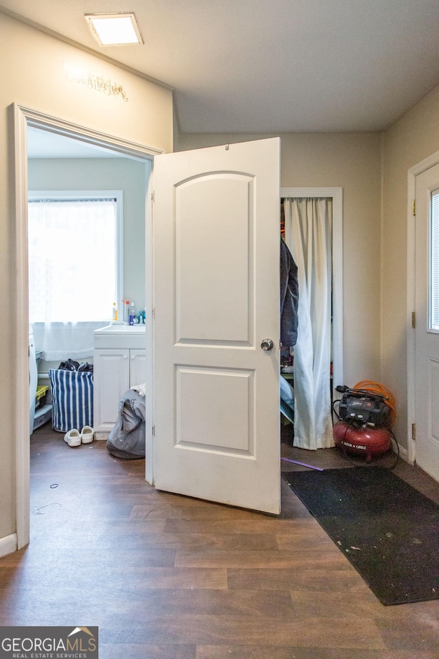 bedroom with wood finished floors, a closet, and a sink