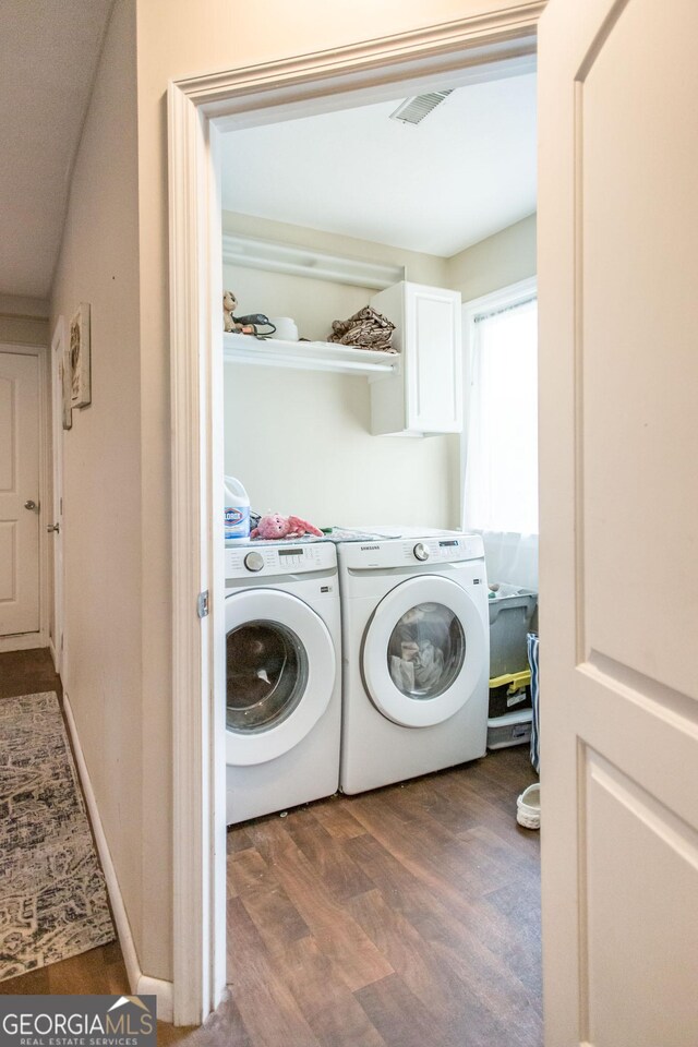washroom featuring wood finished floors and washing machine and clothes dryer