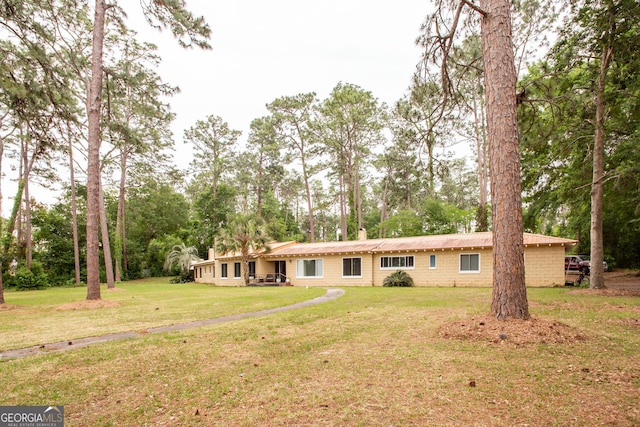 1002 Cherokee Cir, Waycross, GA 31501 - view of front of home featuring a front lawn, metal roof, and view of wooded area