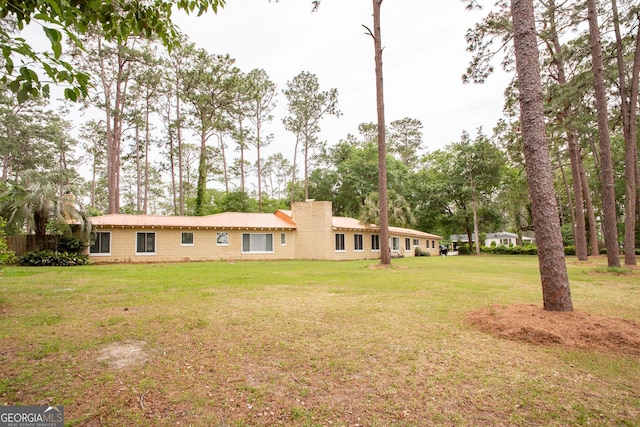 view of front of property with a front lawn and a chimney