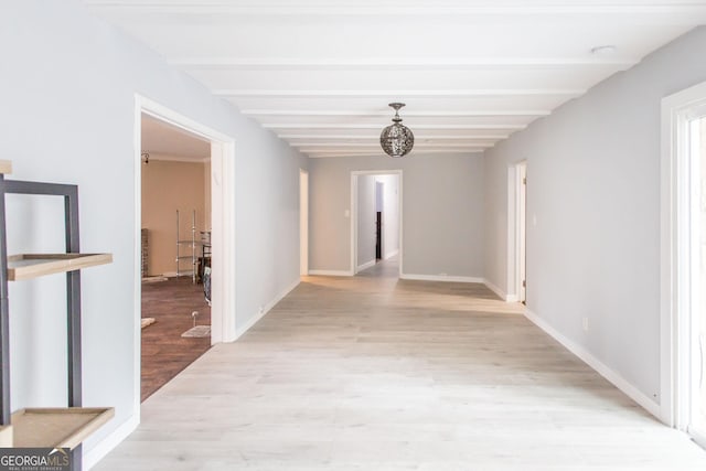 hallway featuring light wood-type flooring, beamed ceiling, baseboards, and a chandelier