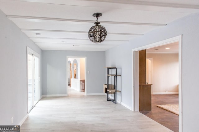 1002 Cherokee Cir, Waycross, GA 31501 - hall featuring light wood-type flooring, beam ceiling, arched walkways, and baseboards