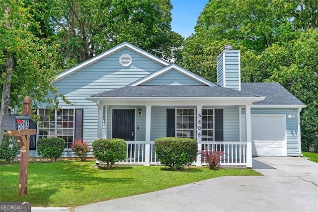 5805 Eagles Feather Ln, Riverdale, GA 30274 - view of front of property with concrete driveway, covered porch, a front lawn, a garage, and a chimney