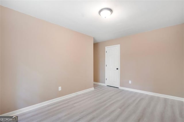 5805 Eagles Feather Ln, Riverdale, GA 30274 - spare room featuring baseboards and light wood-type flooring