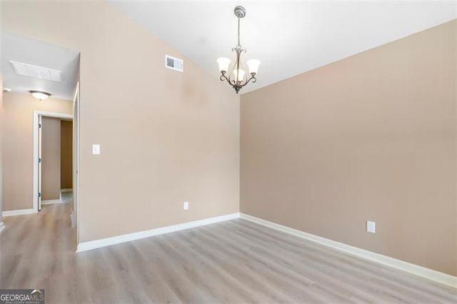5805 Eagles Feather Ln, Riverdale, GA 30274 - unfurnished room featuring a chandelier, light wood finished floors, baseboards, and vaulted ceiling