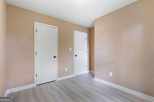 5805 Eagles Feather Ln, Riverdale, GA 30274 - unfurnished bedroom with light wood finished floors and baseboards