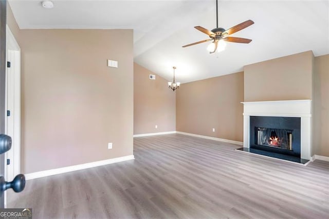 5805 Eagles Feather Ln, Riverdale, GA 30274 - unfurnished living room featuring a ceiling fan, wood finished floors, lofted ceiling, a warm lit fireplace, and baseboards
