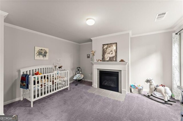 carpeted bedroom featuring ornamental molding, baseboards, and a fireplace
