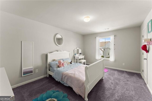 bedroom with carpet floors and baseboards