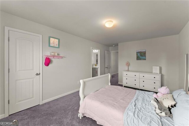 bedroom featuring carpet, baseboards, and ensuite bathroom
