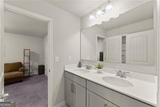 bathroom featuring double vanity and baseboards