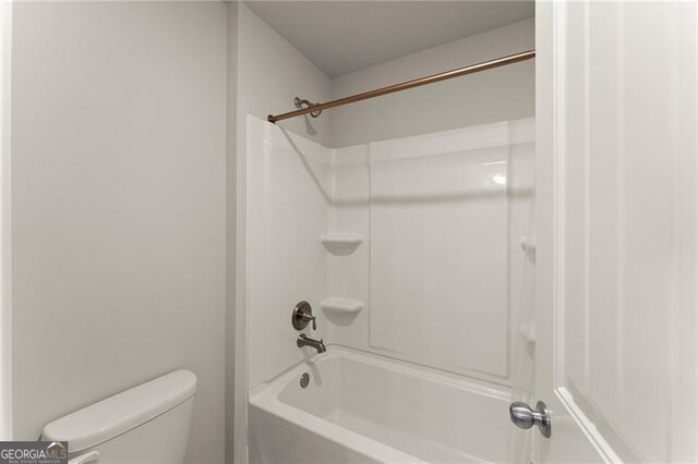 bathroom featuring toilet and shower / tub combination