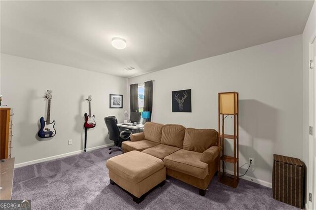 living area featuring carpet flooring, baseboards, and a desk