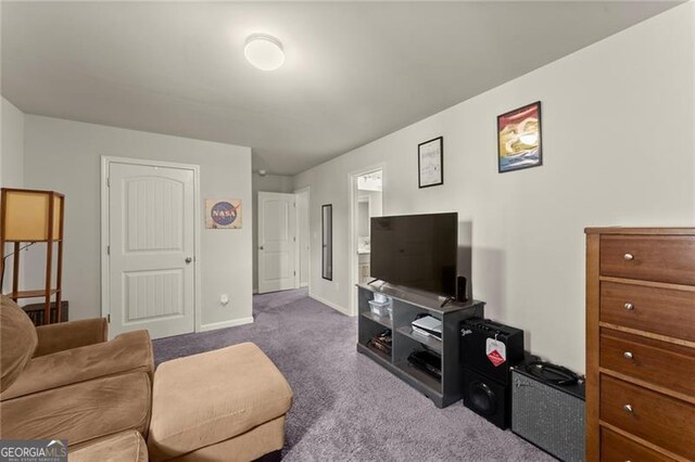 carpeted living area with baseboards
