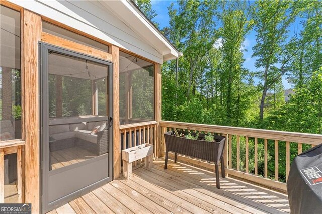 wooden deck with a sunroom