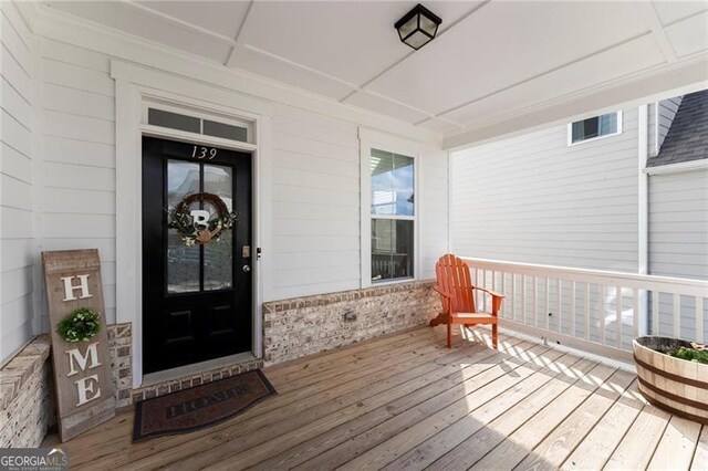entrance to property featuring brick siding