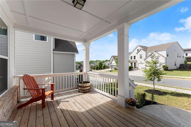 deck with a residential view and covered porch