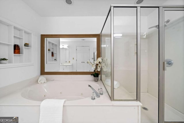 bathroom with a stall shower and a tub with jets