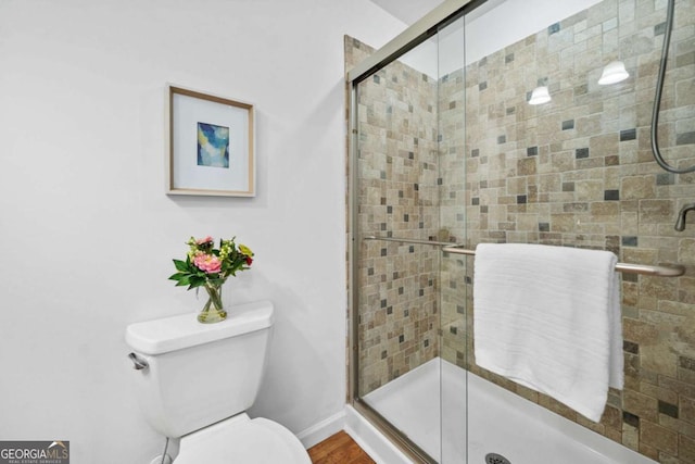 full bath featuring toilet and a stall shower