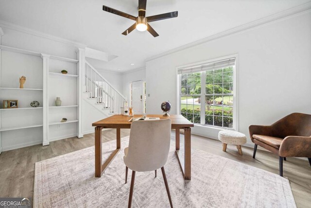 office area with ornamental molding, wood finished floors, a ceiling fan, decorative columns, and baseboards