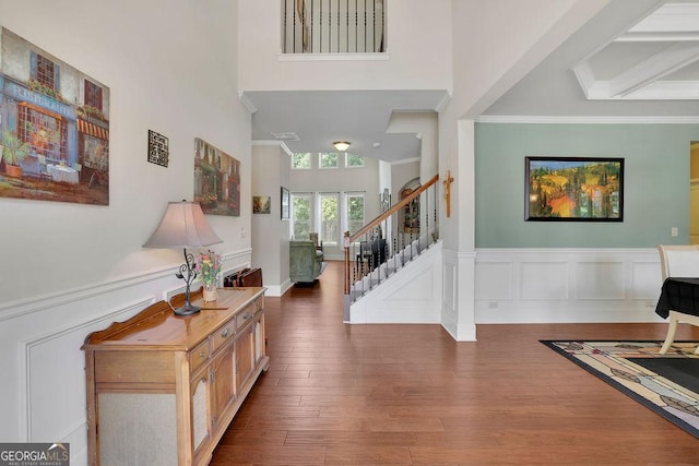 4100 Secret Shoals Way, Buford, GA 30518 - foyer featuring a towering ceiling, crown molding, stairway, wainscoting, and wood finished floors