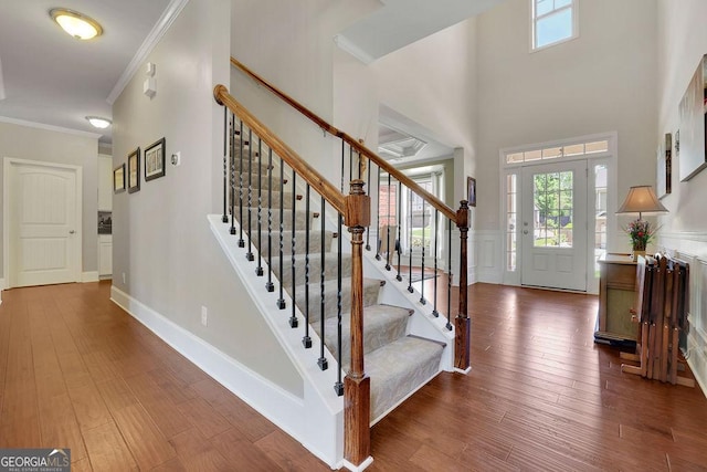 4100 Secret Shoals Way, Buford, GA 30518 - foyer featuring ornamental molding, stairs, wood finished floors, a wainscoted wall, and a high ceiling