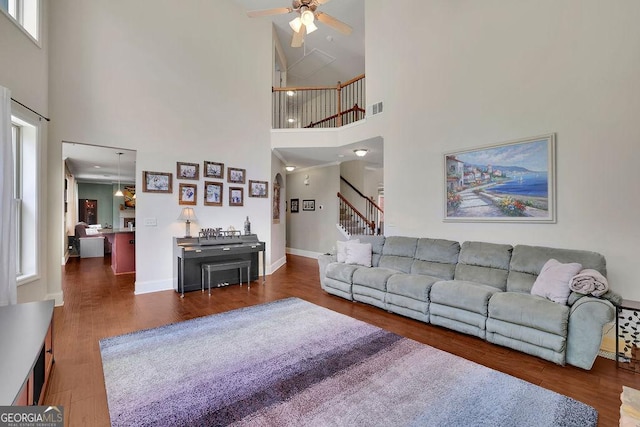 4100 Secret Shoals Way, Buford, GA 30518 - living room featuring high vaulted ceiling, ceiling fan, stairway, wood finished floors, and baseboards