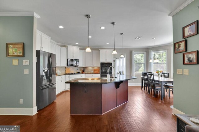 4100 Secret Shoals Way, Buford, GA 30518 - kitchen with black appliances, a sink, crown molding, baseboards, and dark wood-type flooring