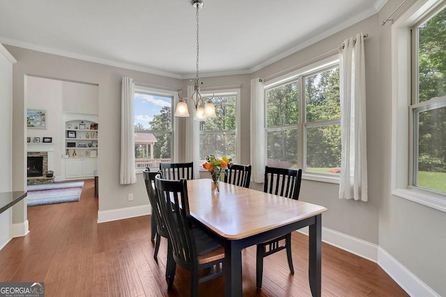 4100 Secret Shoals Way, Buford, GA 30518 - dining space with a chandelier, plenty of natural light, dark wood-style flooring, and ornamental molding