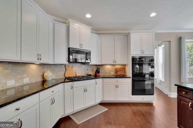 4100 Secret Shoals Way, Buford, GA 30518 - kitchen featuring black appliances, dark wood-type flooring, dark stone counters, backsplash, and white cabinetry
