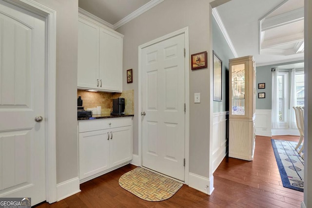 4100 Secret Shoals Way, Buford, GA 30518 - kitchen with dark wood-style flooring, crown molding, tasteful backsplash, white cabinetry, and beam ceiling